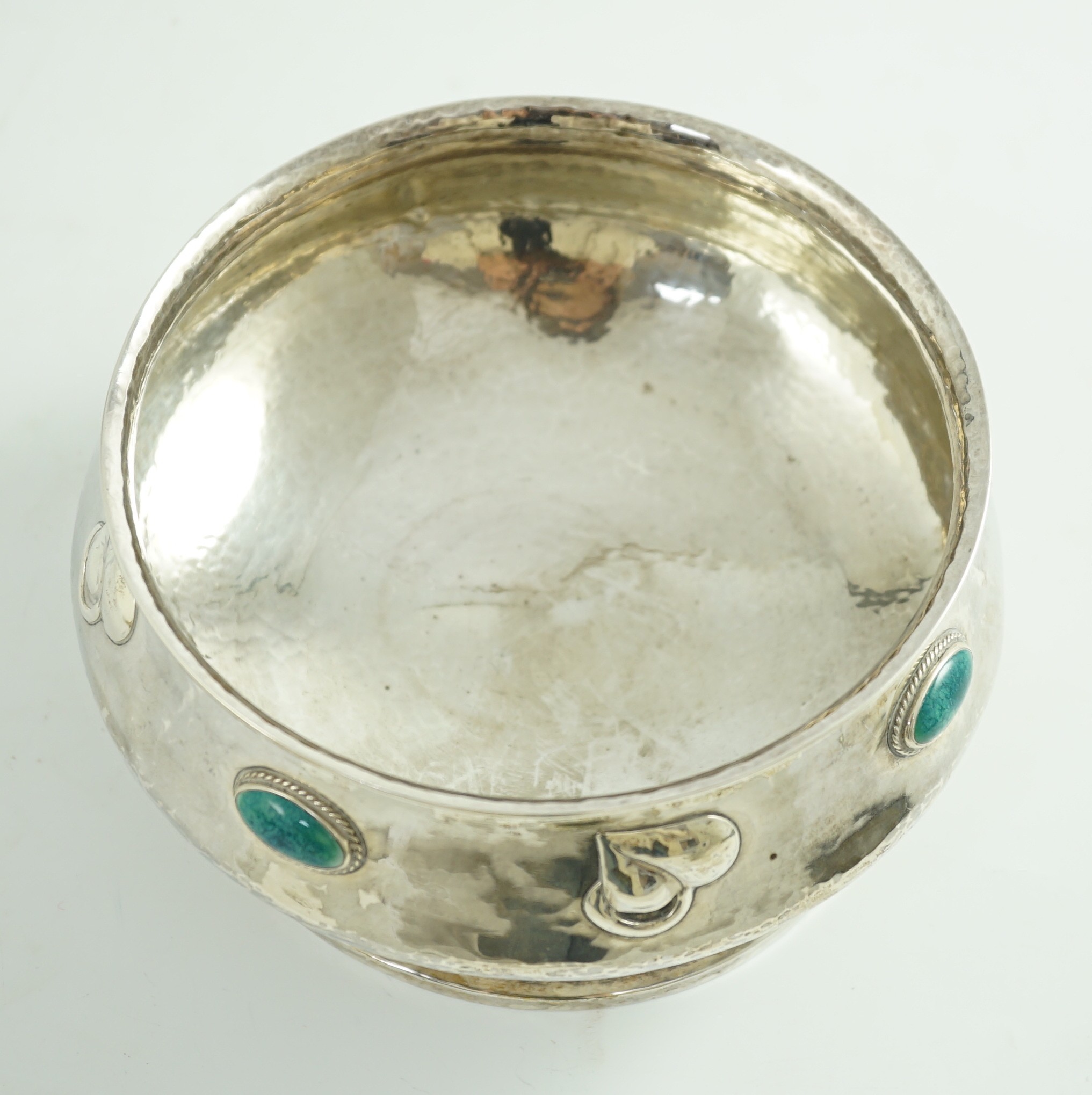 An Edwardian Art Nouveau silver pedestal bowl, inset with four oval Ruskin oval cabochons, by Albert Edward Jones